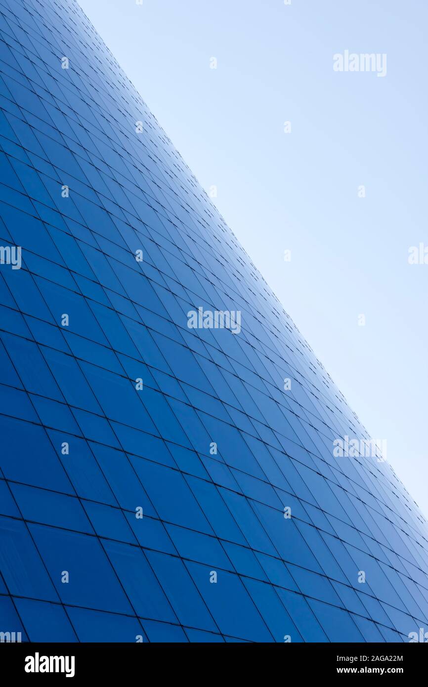 Blue glass windows business building facade and sky background. Stock Photo