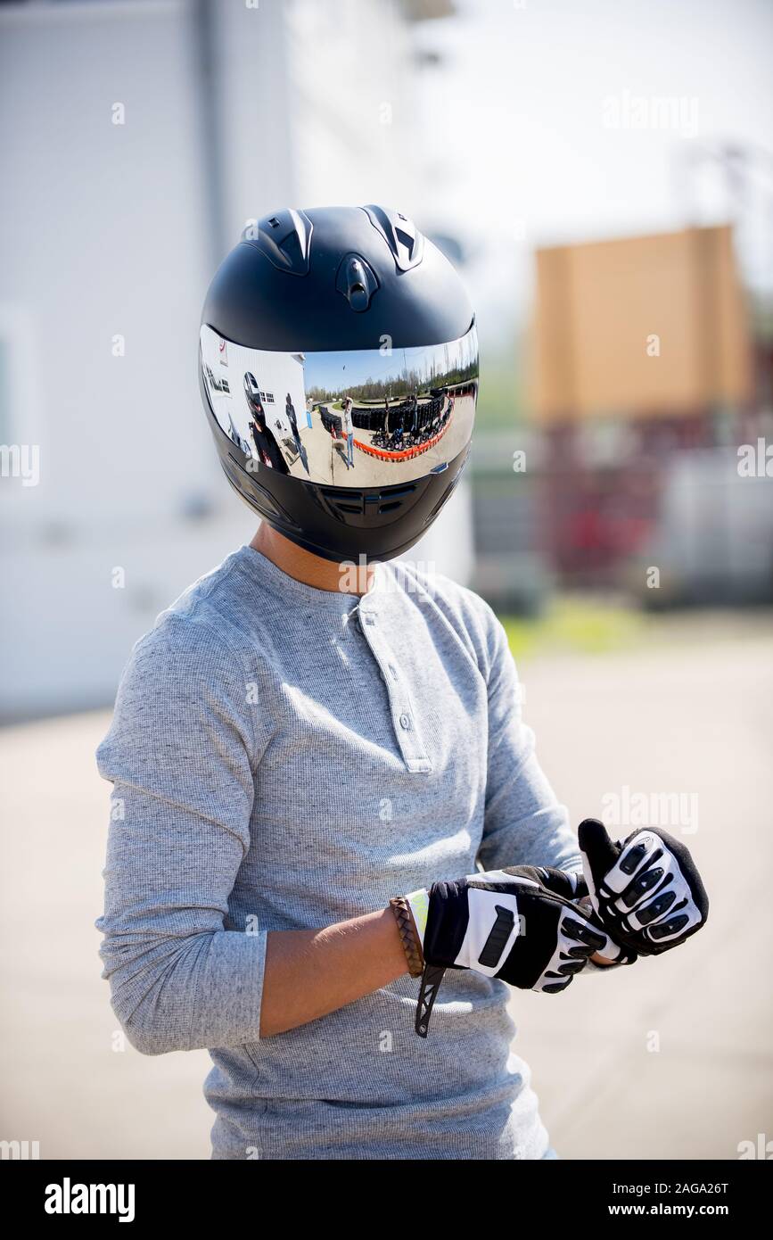 a person wearing motorcycle helmets Vertical shot of a person wearing a motorcycle helmet Stock Photo