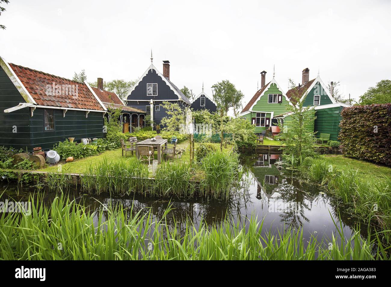 A Range Of Cute Small Houses Near The Lake Surrounded By Green