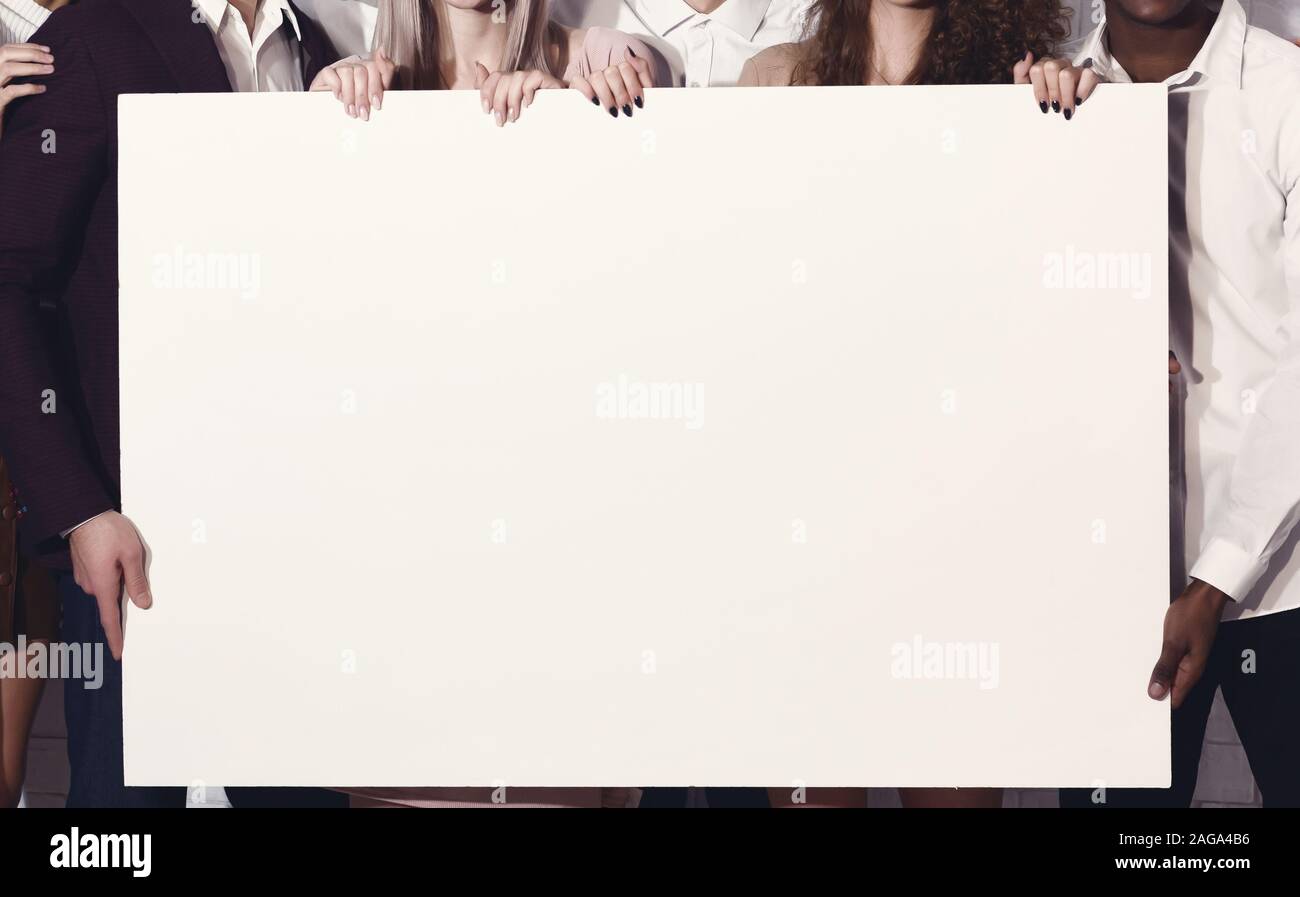 Unrecognizable Young People Holding Blank White Poster Standing Indoor ...
