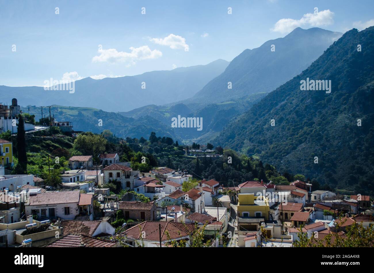 Low angle shot of a small village surrounded by beautiful mountainous ...