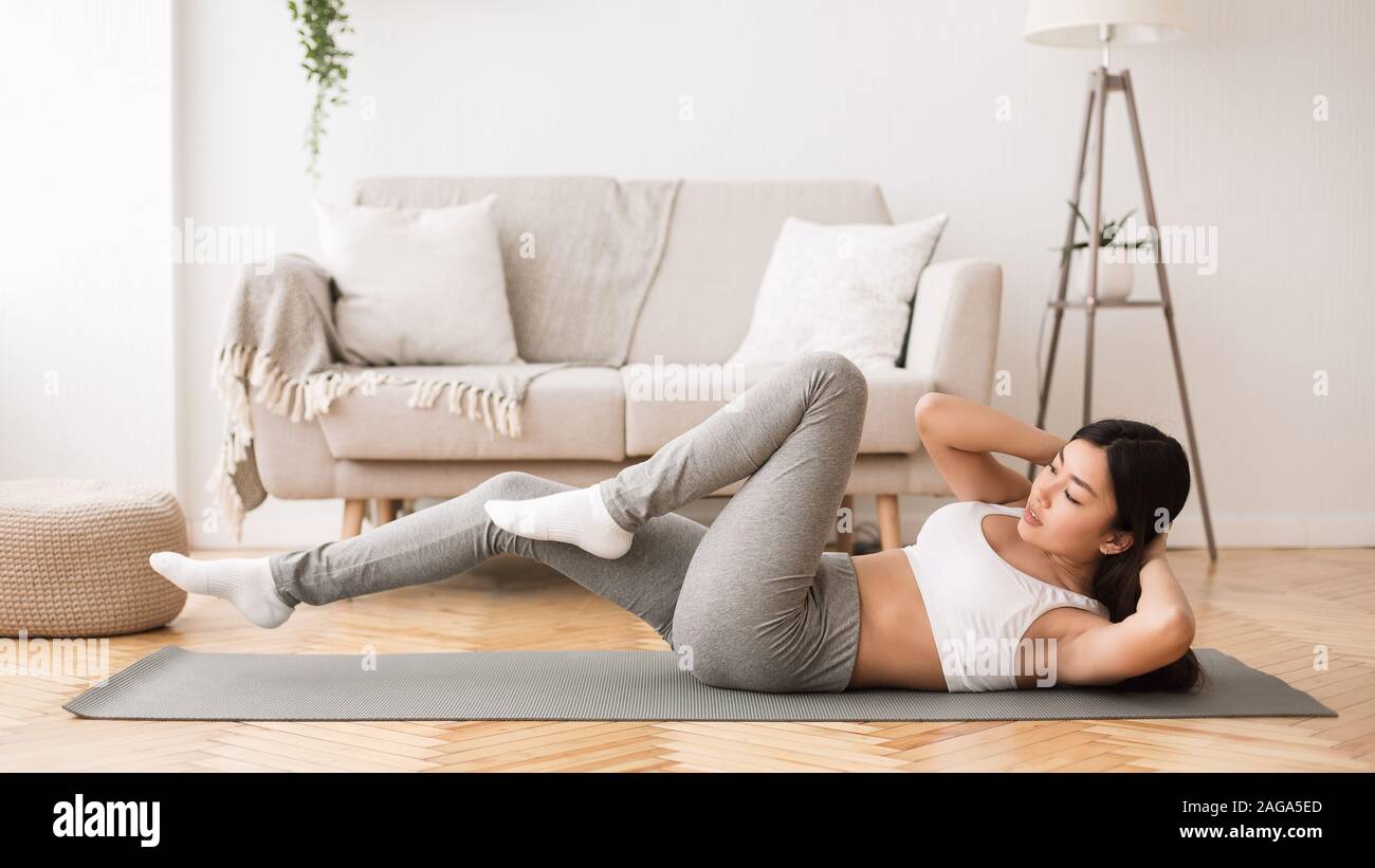 Home fitness. Girl doing abs crunches on floor Stock Photo Alamy