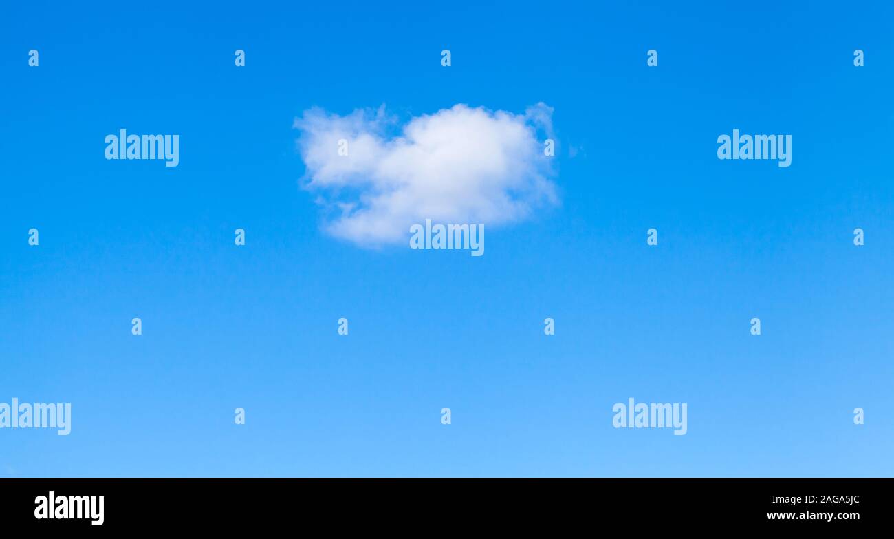 Small white cloud in clear blue sky at daytime, natural background photo Stock Photo