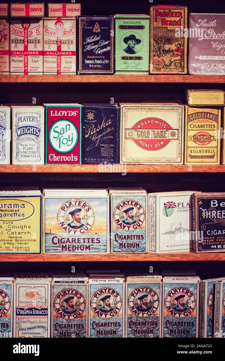 CORNWALL, UK - JUN 28, 2016.  A Tobacconist shelves stacked with packets and tins of old cigarettes, tobacco and cigars such as Players Navy Cut Stock Photo