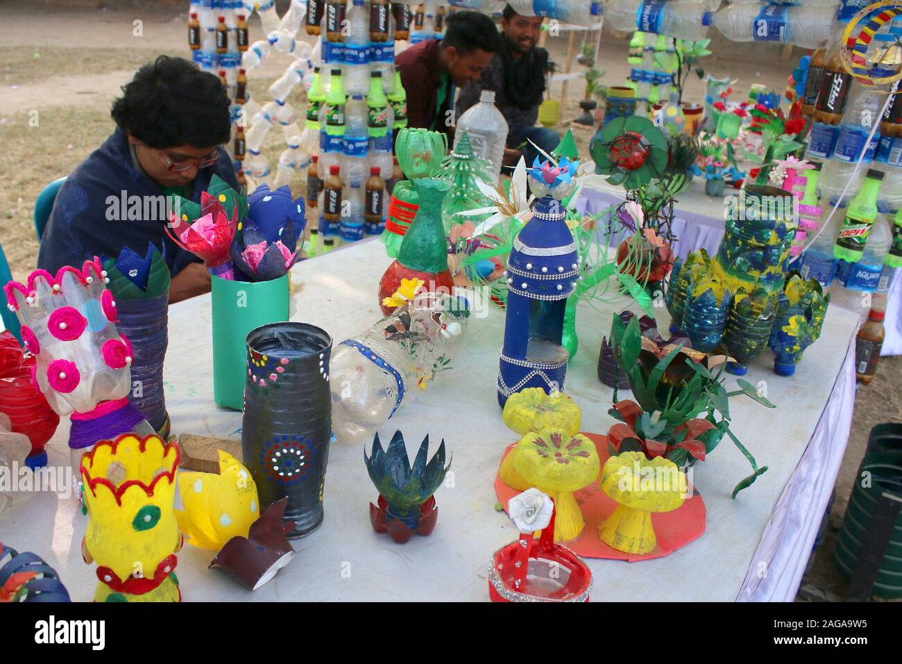 Several objects made out of empty plastic bottles collected by the BD Clean members are displayed at the exhibition.BD Clean members collected 3 million empty plastic bottles from various parts of Bangladesh as a homage to the three million martyrs who sacrificed their lives in the Liberation War of 1971. Artistes crafted various objects, including a mural of Bangabandhu, boats and the map of Bangladesh, using the scraps. The works were put on display at Mohakhali's T&T Colony playground in Dhaka on the eve of Victory Day. Stock Photo
