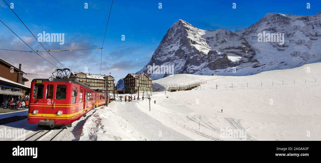 Panoramic of Jungfraujoch train at Kleiner Scheidegg in winter snow with The Eiger (left) then The Monch Mountains. Swiss Alps Switzerland Stock Photo
