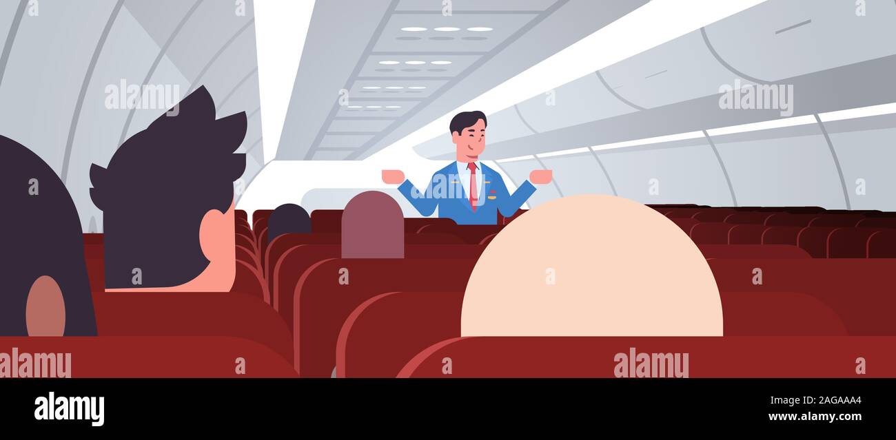 steward explaining instructions for passengers male flight attendant in