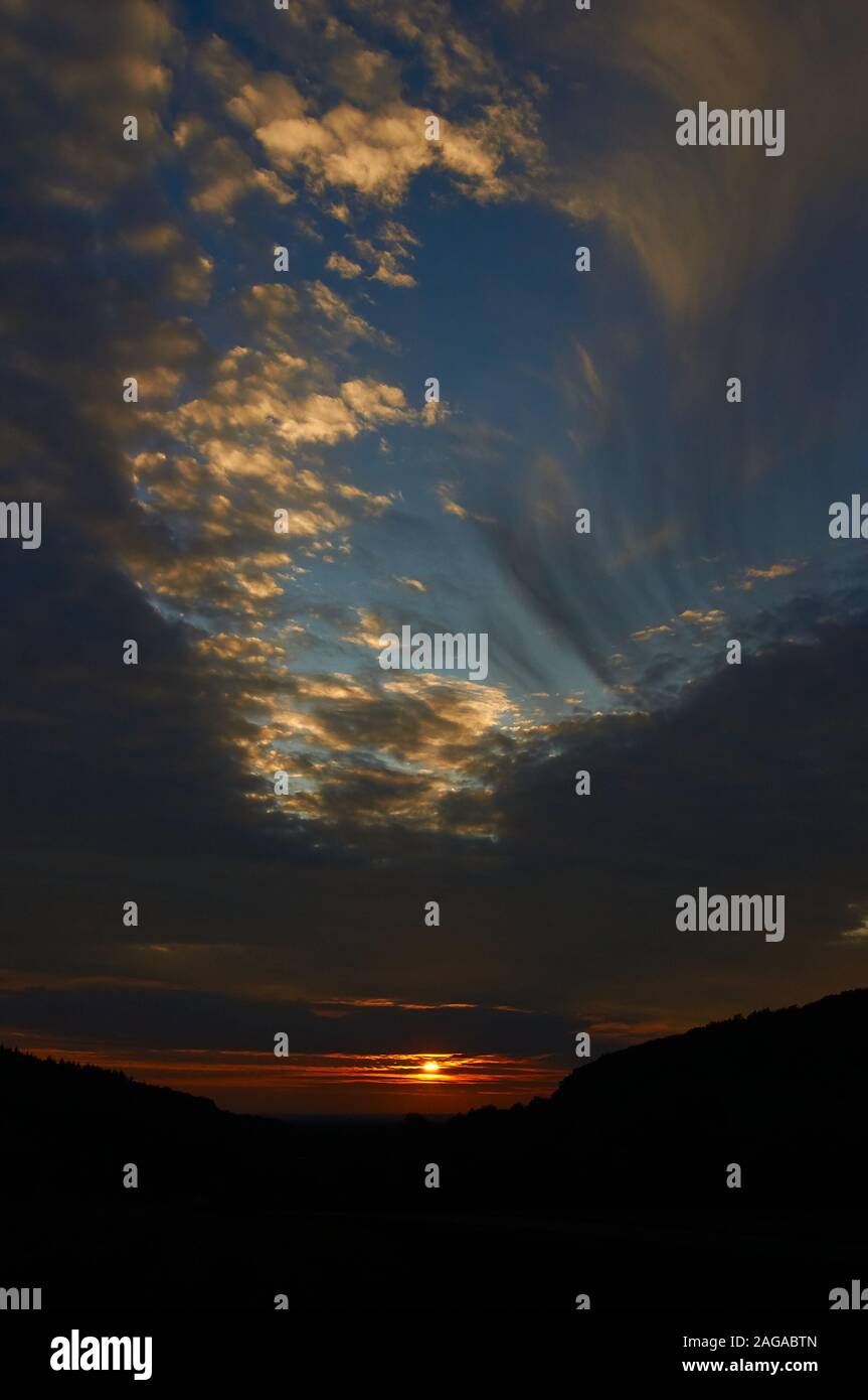 sunset sky with punch hole clouds Stock Photo