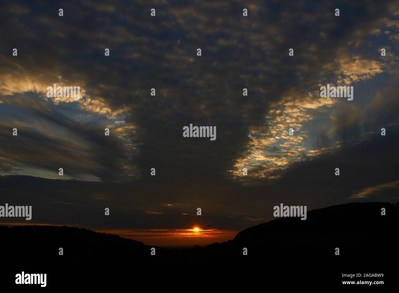 sunset sky with punch hole clouds Stock Photo