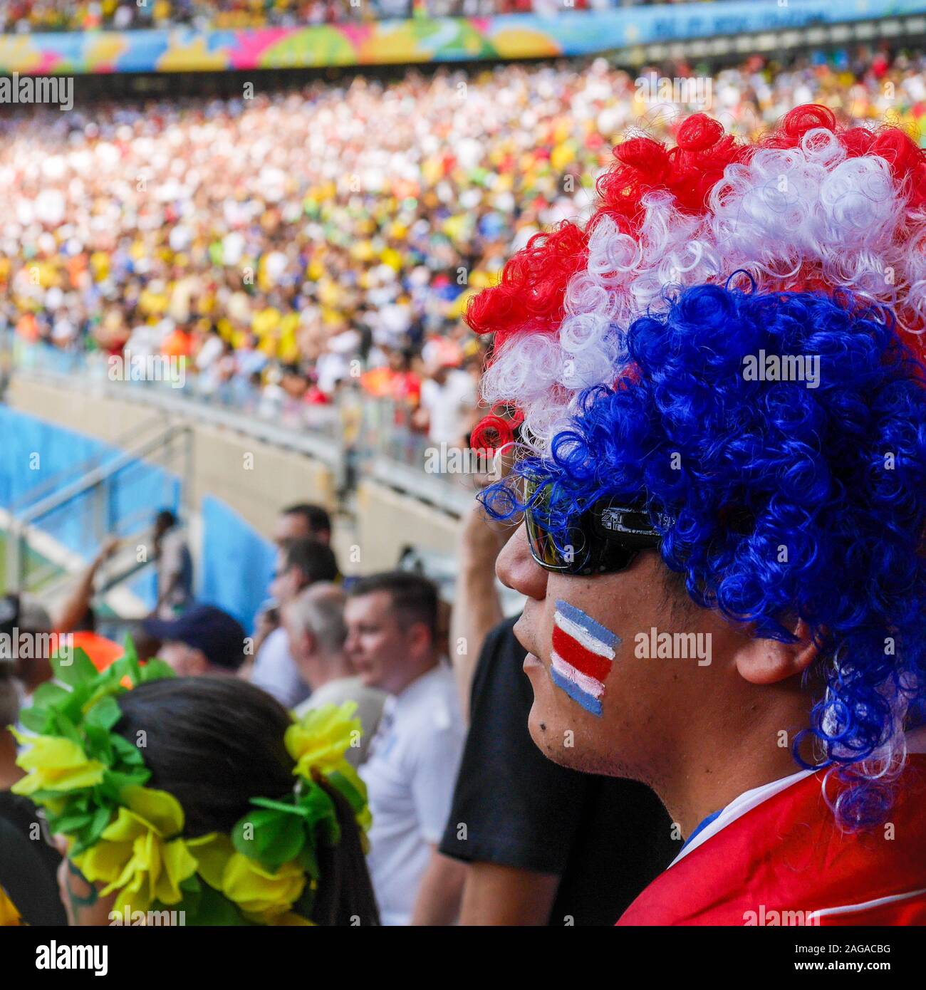 A Costa Rica soccer fan supporting his national team at an International football game, playing England in the 2014 World Cup. Stock Photo