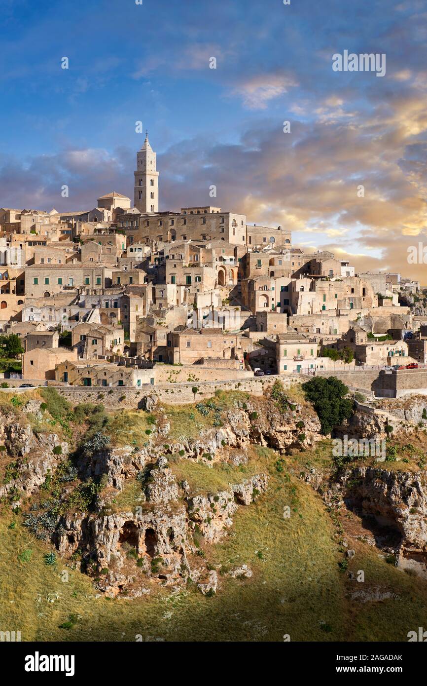 Long view across "la Gravina" ravine to the Sassi of Matera at sunrise, Basilicata, Italy. A UNESCO World Heritage site.  The area of Matera has been Stock Photo