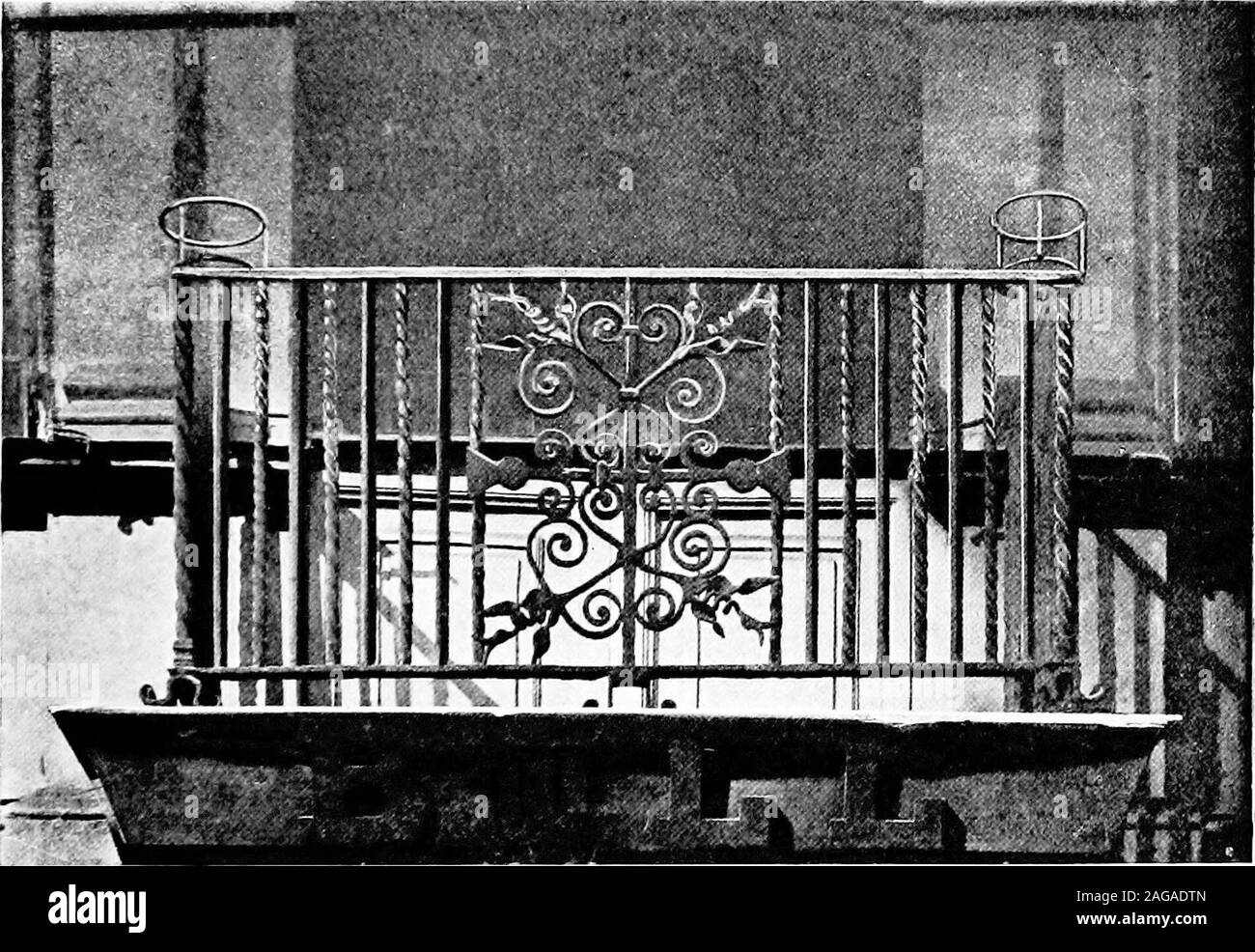 . English ironwork of the XVIIth & XVIIIth centuries; an historical & analytical account of the development of exterior smithcraft. FIG. 97. TOWN HALL, WALLINGFORD. Balconies 257 repeats the twisted verticals and extra standards with ball finials andthree scrolled panels in front, more or less restored. Those atGuildford, dating from 1683, are finer. In the large balcony to theTown Hall the vertical bars are alternately plain and twisted,and the standards twisted and surmounted by faceted balls, witha central panel, the scrolls terminating in thistles, repeating fourways with simpler and corre Stock Photo