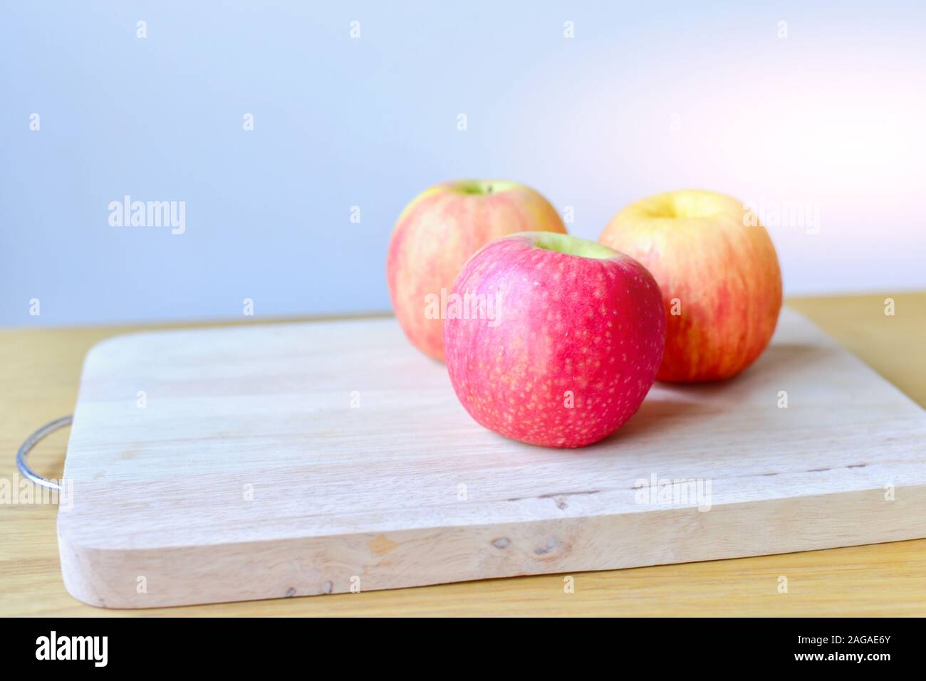 Fresh Red Apples Isolated on Cutting Board Stock Photo