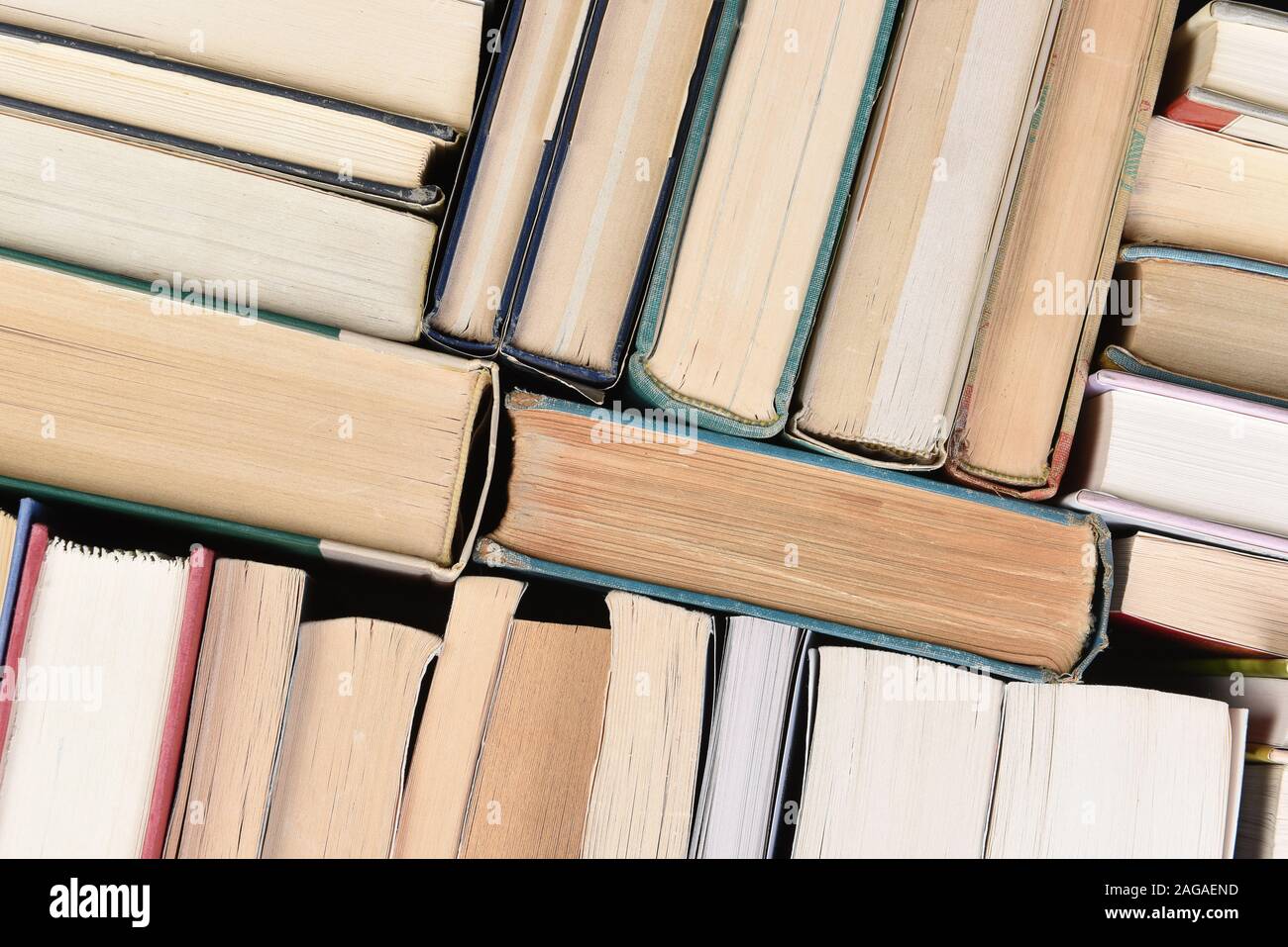 Closeup of a large group of used books in random order seen from directly above. Stock Photo
