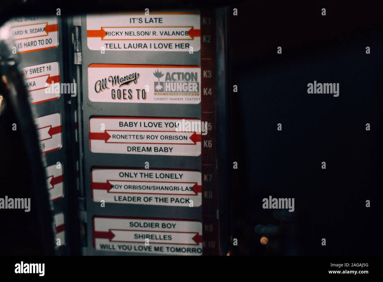BIRMINGHAM, UNITED KINGDOM - Aug 26, 2017: A jukebox music device at a restaurant displaying the selection available for playback. Stock Photo