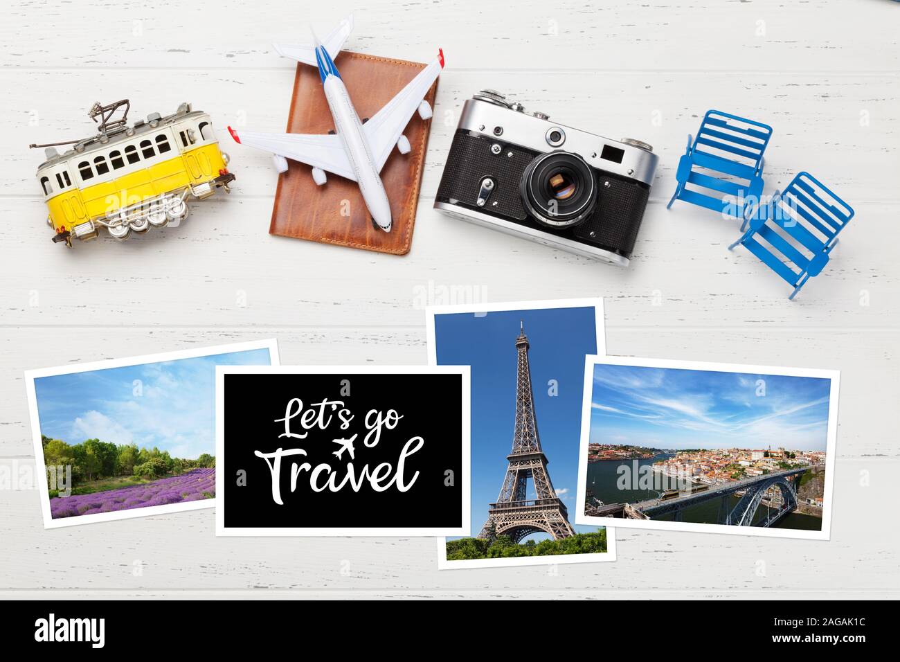 Travel concept with photos, airplane toy, camera and passport. Top view flat lay with copy space Stock Photo