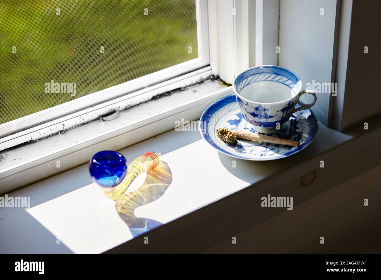 Download A High Angle Shot Of A Marijuana Blunt And Dry Cannabis On A Coffee Cup Near The Window Stock Photo Alamy Yellowimages Mockups