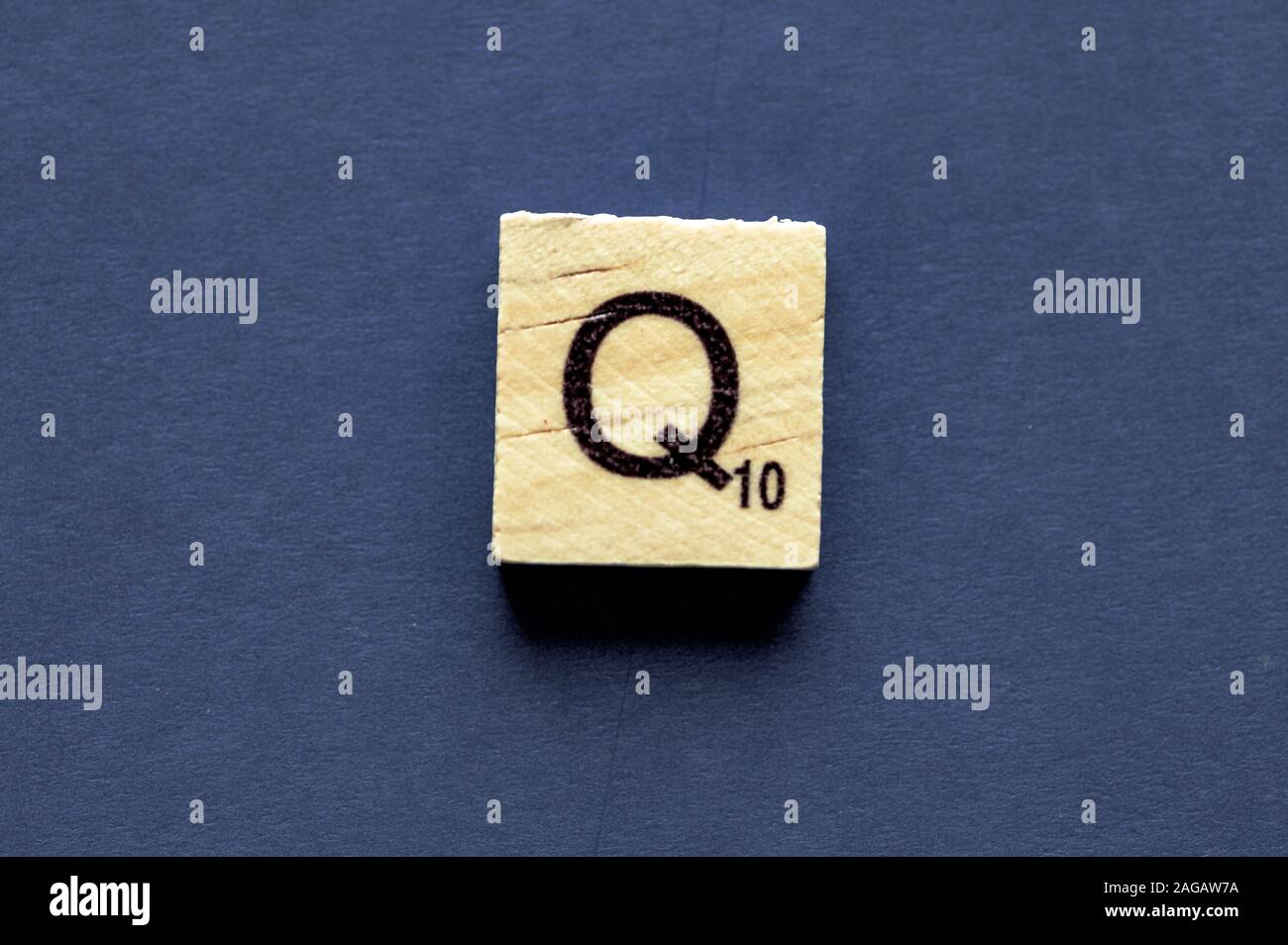 Letter Q on a wooden cube from a wordplay board game Stock Photo - Alamy