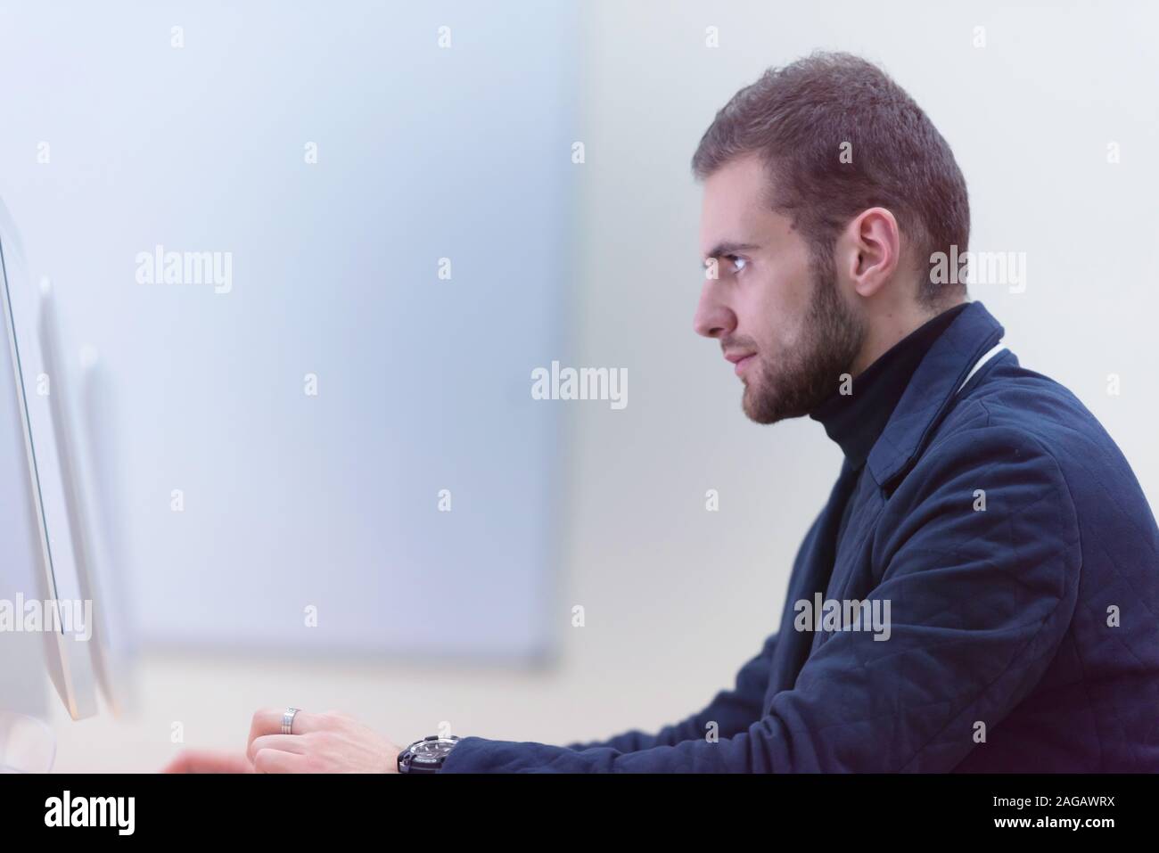 Young male Businessman working on modern computer. Businessman using innovative technologies. Businessman working on computer, software developing wit Stock Photo