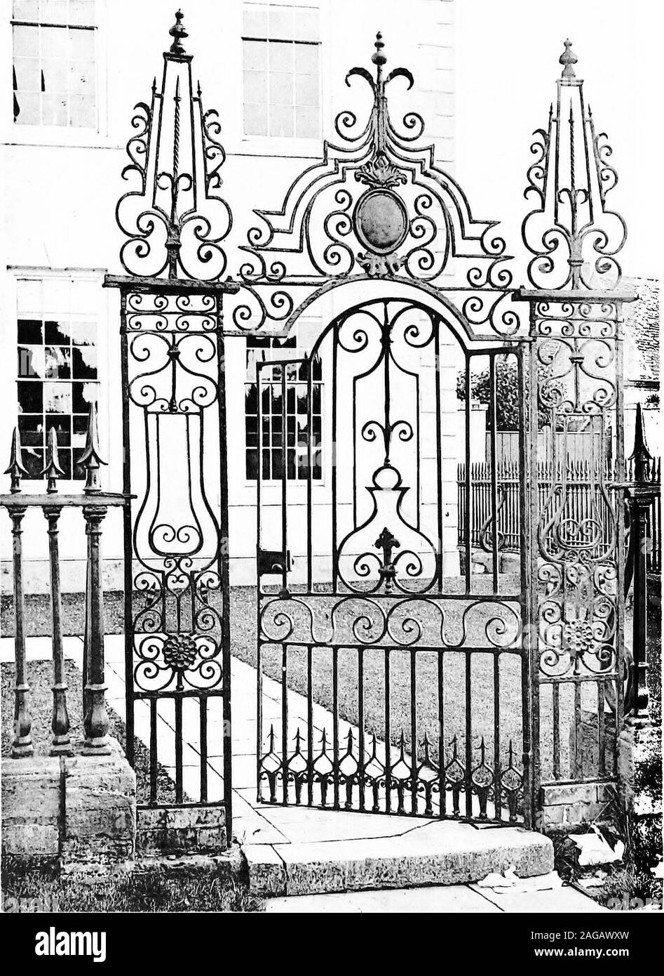 . English ironwork of the XVIIth & XVIIIth centuries; an historical & analytical account of the development of exterior smithcraft. ENTRANCE TO THE ABBEY HOUSE, SHREWSBURY Plate LXIV,. GATE AT EVESHAM, WORCESTERSHIRE. Country Gates 199 noticeable for the large overthrow with acanthus and laurelround a monogram of J.B. (p. 79). Worcestershire.—^Apart from the fine screen with gates in front ofthe GuildhalljWorcester, b^Bakewell, (p. 63) which has beenruinedbyreconstruction and the renewal of the foliage some thirty years ago,there are no interesting eighteenth century gates in the city ; andind Stock Photo