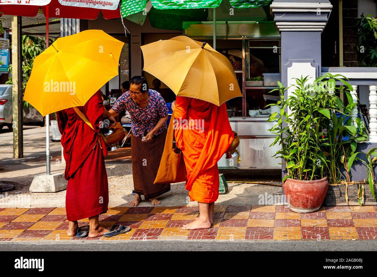 Buddhist Monks Collecting Alms, Phnom Penh, Cambodia. Stock Photo