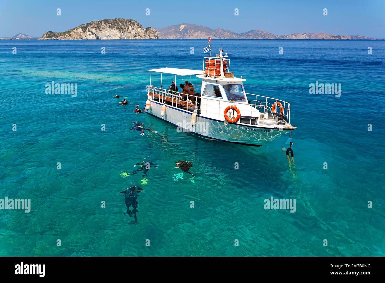 Scuba diver in water at the diving boat, Limni Keriou, Zakynthos island, Greece Stock Photo