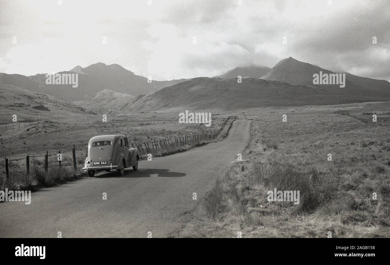 1950s, historical, motorcar of  the era parked on a  narrow country road at Long Mynd, Shropshire, England, a heath and moorland plateau, of which in 1965 large areas, almost all its upland area, were brought by the National Trust and designated as an area of outstanding natural beauty (ANOB). Stock Photo