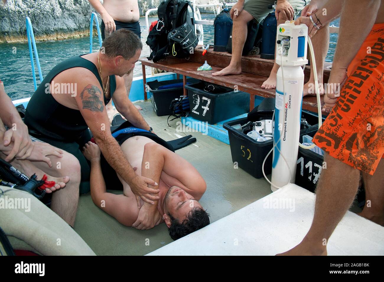 Diving accident, diver subserve the victim with pure oxygen on a dive boat, Limni Keriou, Zakynthos island, Greece Stock Photo