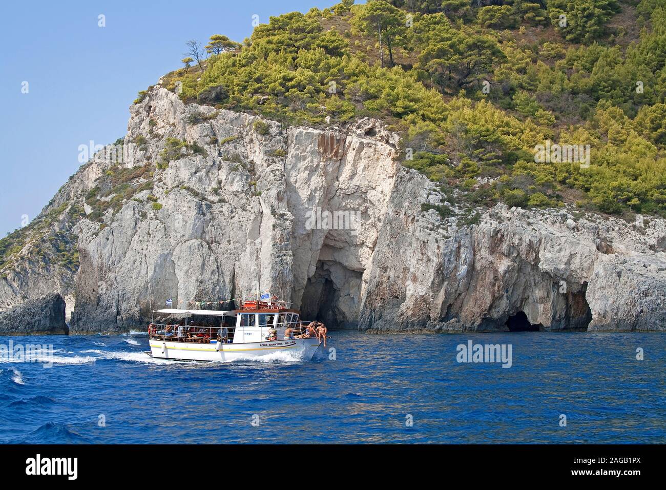 Dive boat at the rocky coast, Limni Keriou, Zakynthos island, Greece Stock Photo