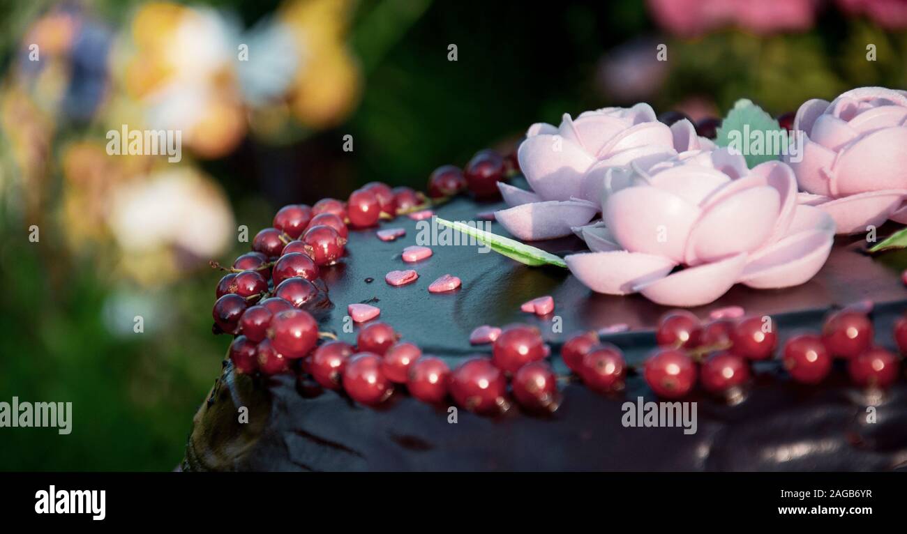 chocolate cake decorated with flowers, berries and hearts Stock Photo
