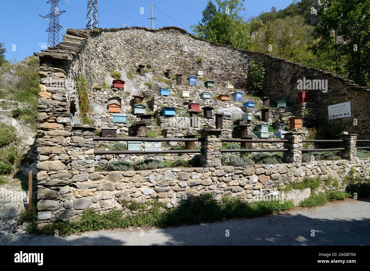 Different Models of Beehives in a Walled Apiary or Apiary Surrounded by Dry Stone Wall at La Brigue in the Roya Valley Alpes-Maritimes France Stock Photo