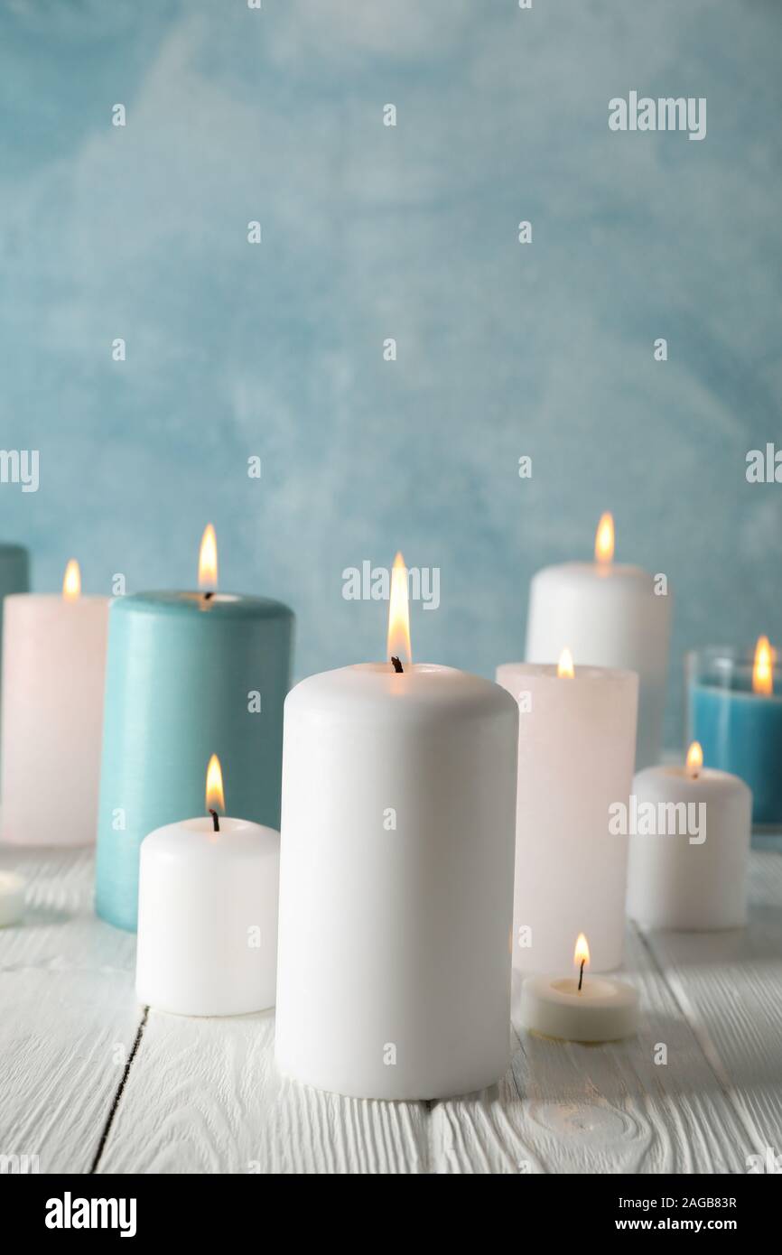 Different burning candles against blue background, space for text Stock ...