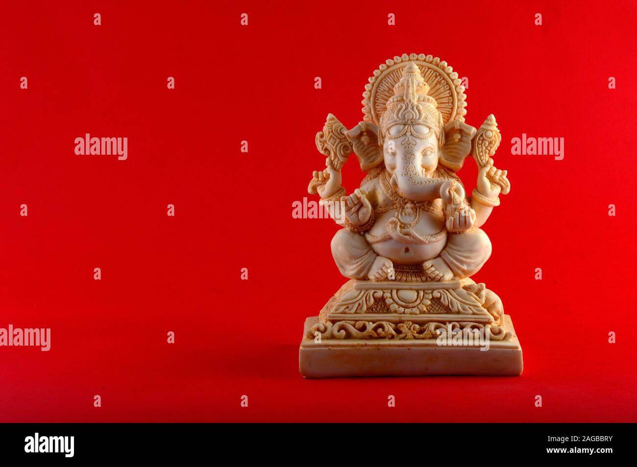 Hindu God Ganesha. Ganesha Idol on red background Stock Photo - Alamy