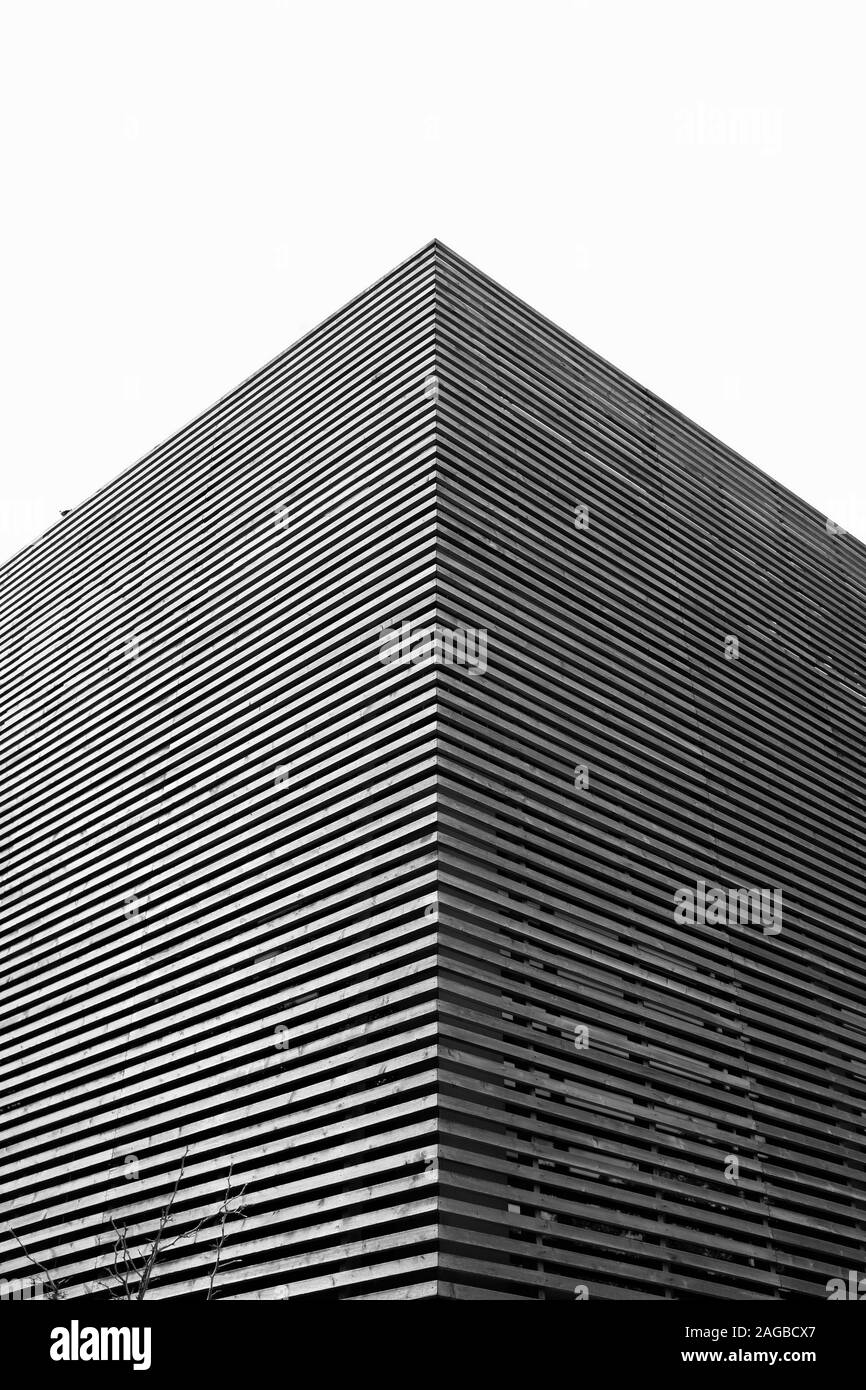 Vertical greyscale shot of a concrete building with interesting ...