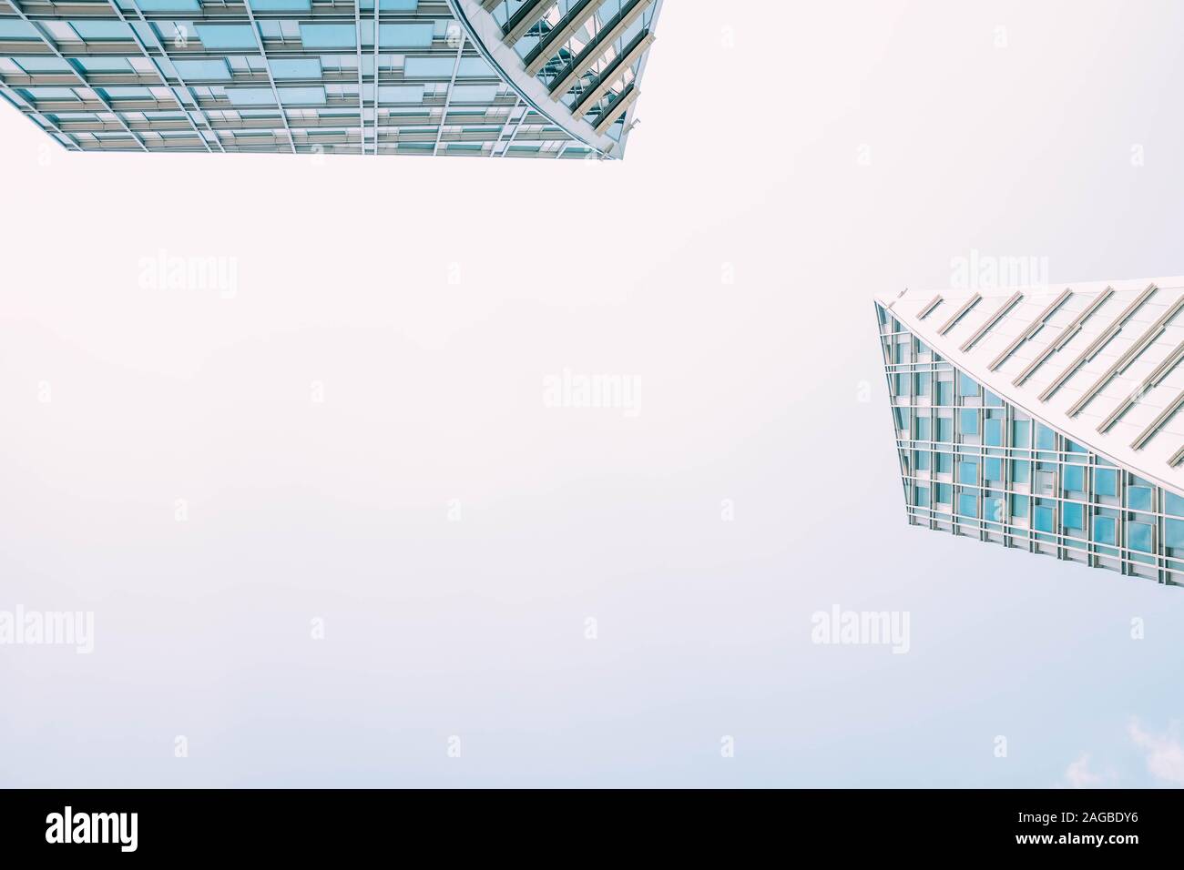 Low angle shot of two modern skyscrapers with blue and white windows ...