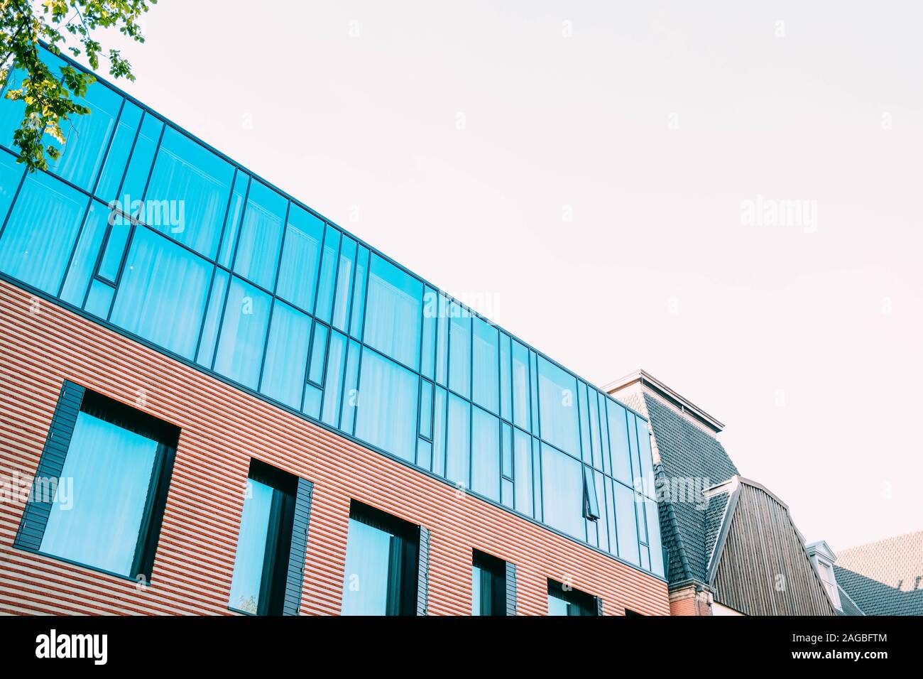 Low angle shot of a concrete building with a glass facade under the ...