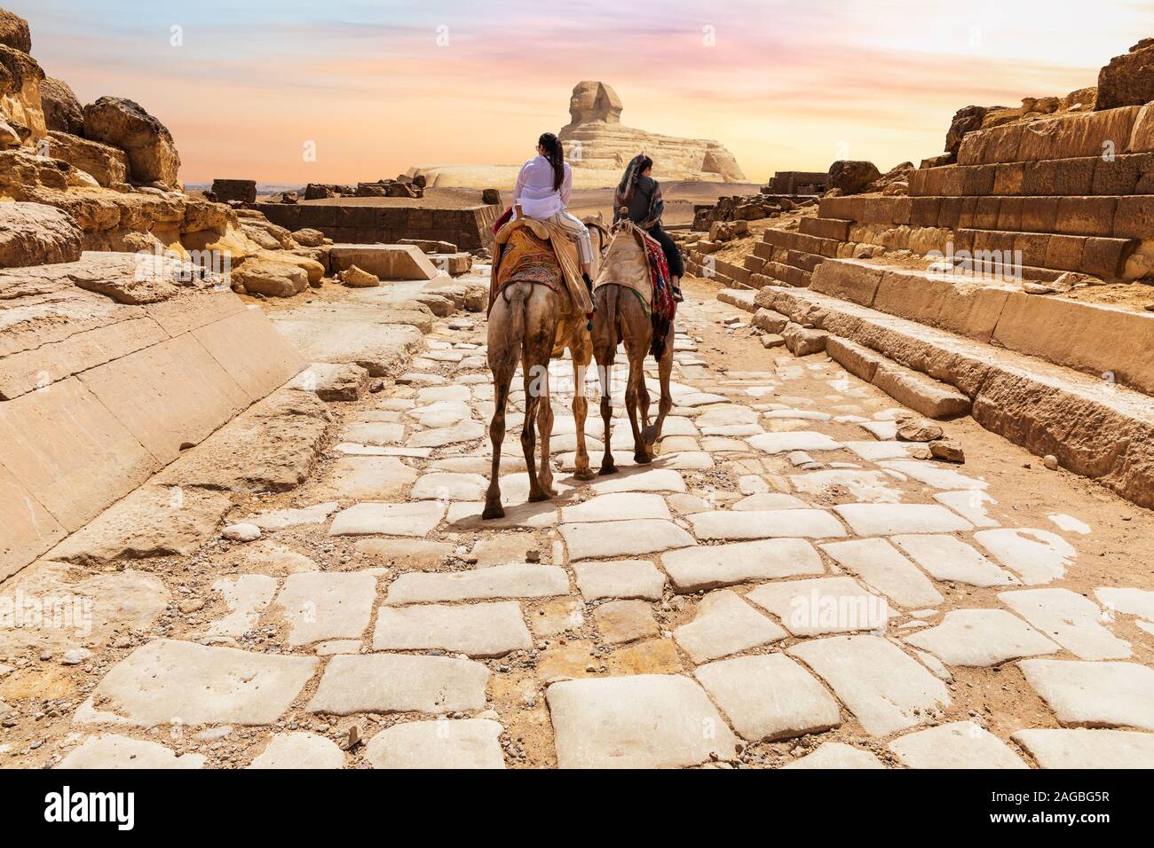 Tourists on camels in the temple of Giza near the Great Sphinx, Egypt Stock Photo
