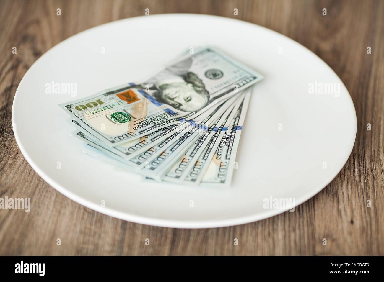 Plate with money. Greedy corruption concept. Bribe idea Stock Photo