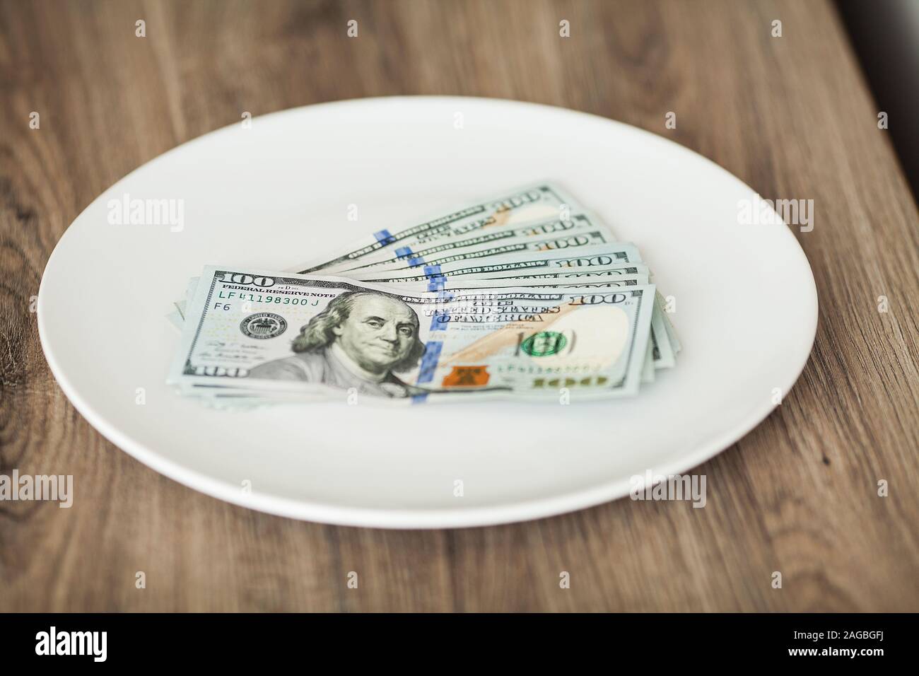 Plate with money. Greedy corruption concept. Bribe idea Stock Photo