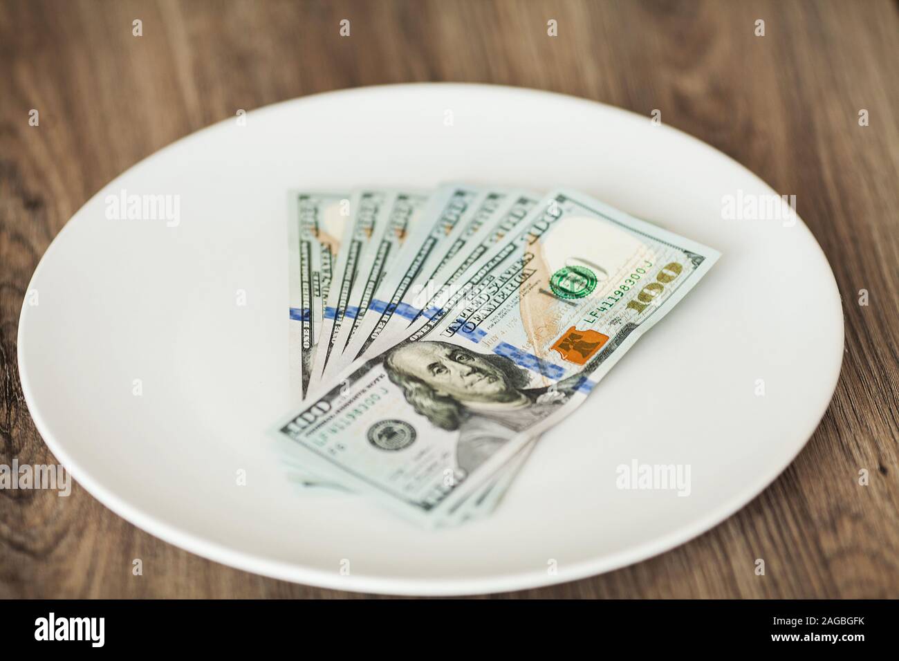 Plate with money. Greedy corruption concept. Bribe idea Stock Photo