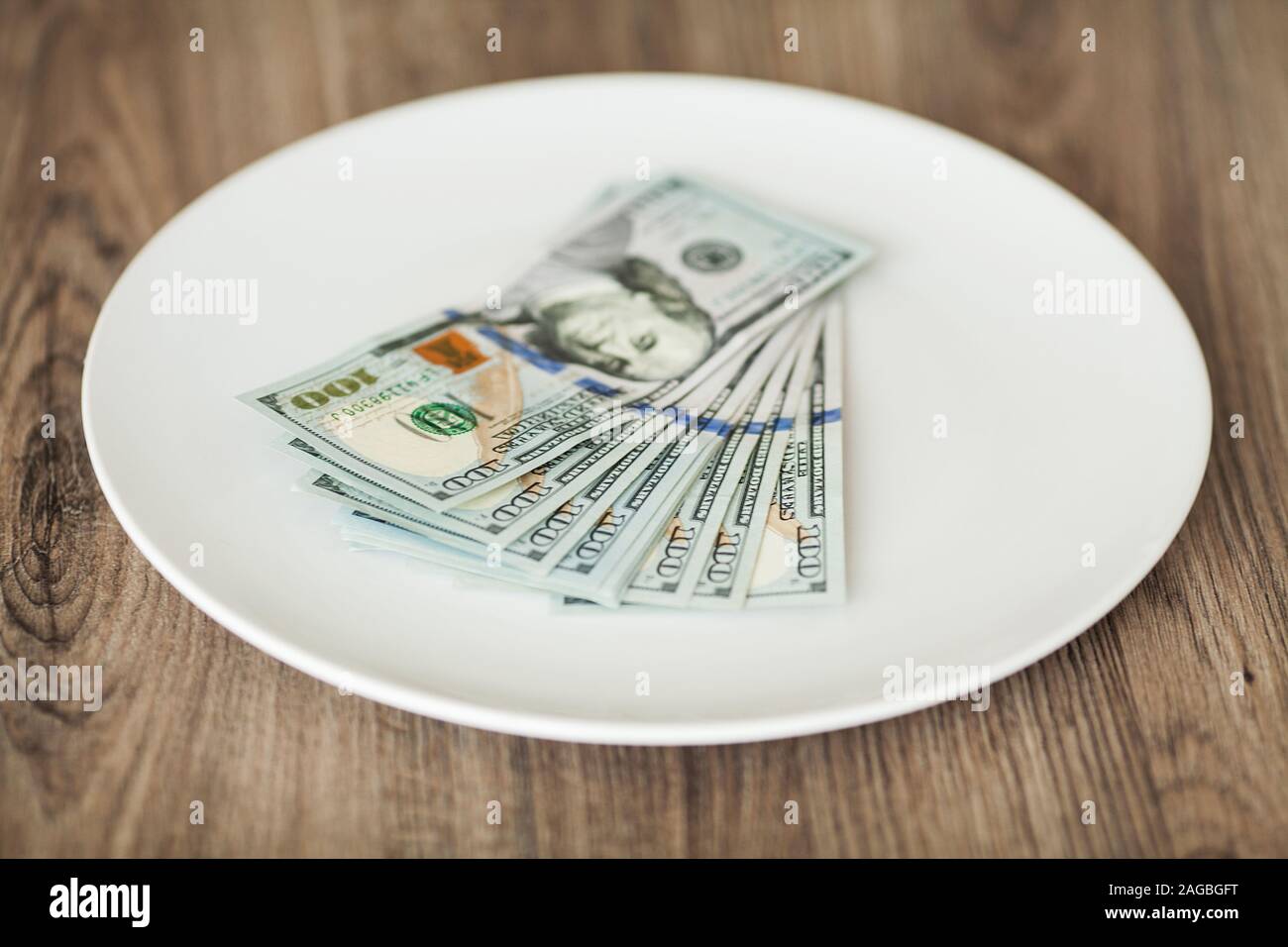 Plate with money. Greedy corruption concept. Bribe idea Stock Photo