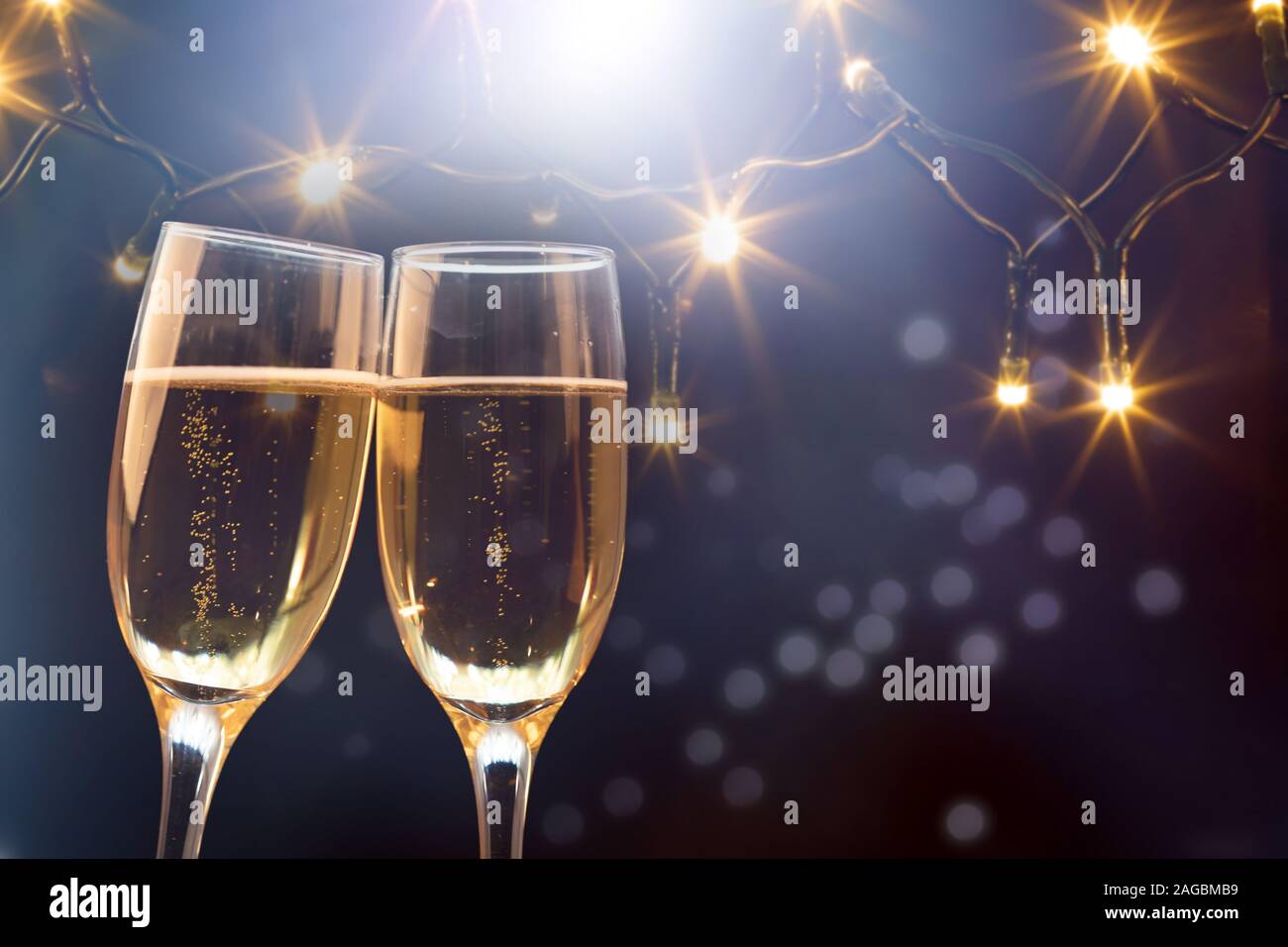 Champagne glasses on sparkling holiday background - Celebrating the New ...