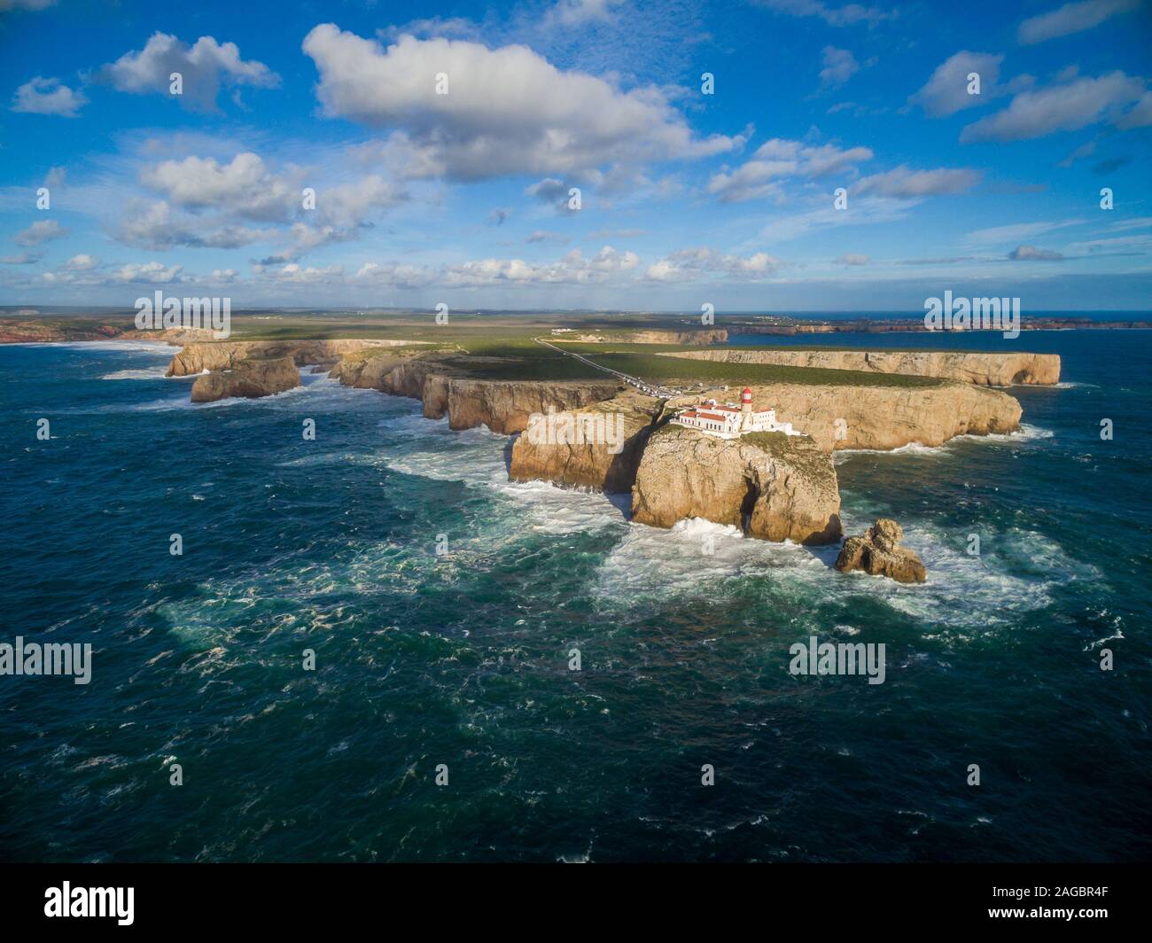 High shot landscape of an island with a palace on it surrounded by sea under a blue sky in Portugal Stock Photo