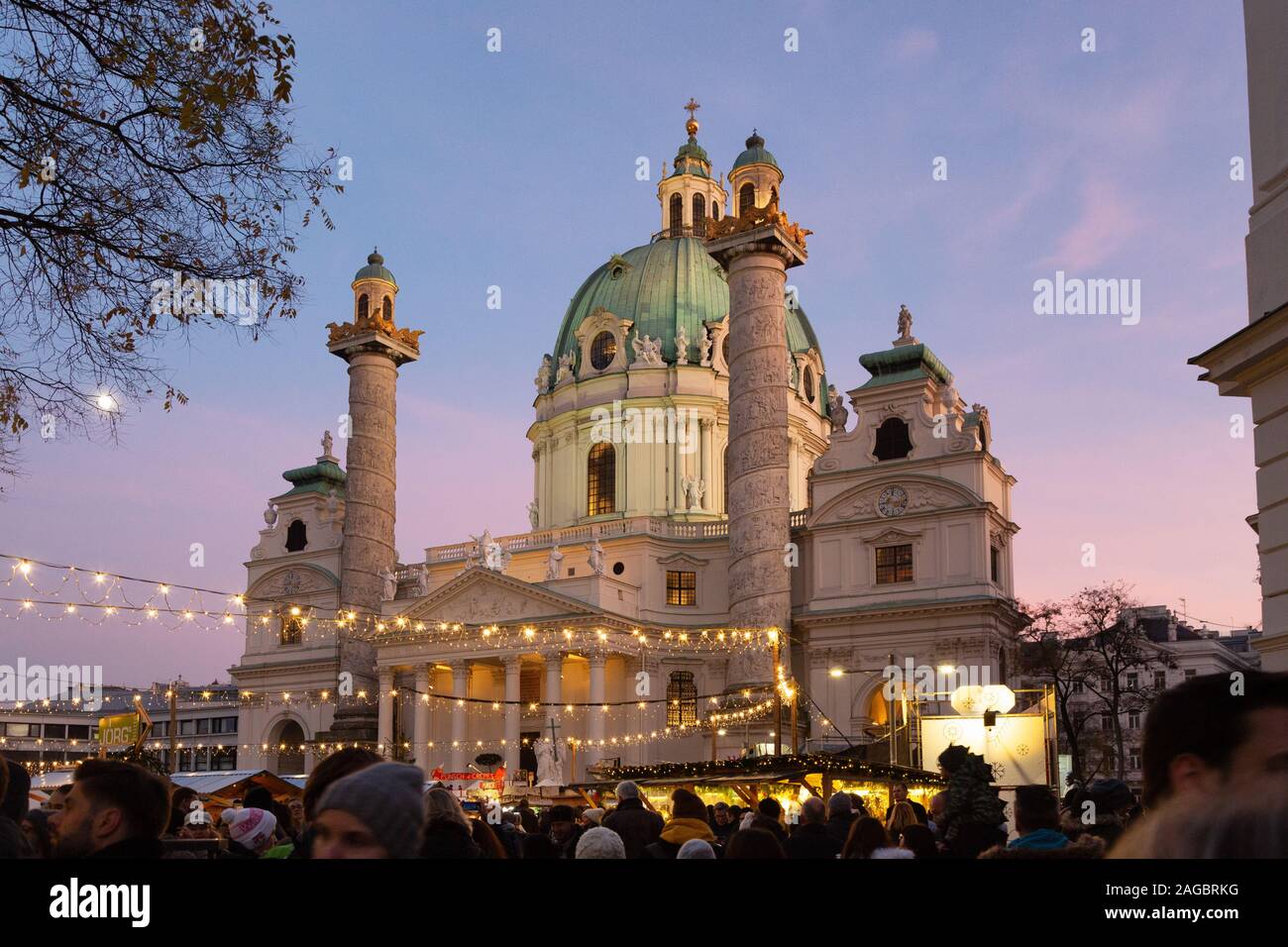 St Charles Church Vienna (Karlskirche Wien), outside, and christmas market, at dusk in winter; Vienna Austria Europe Stock Photo