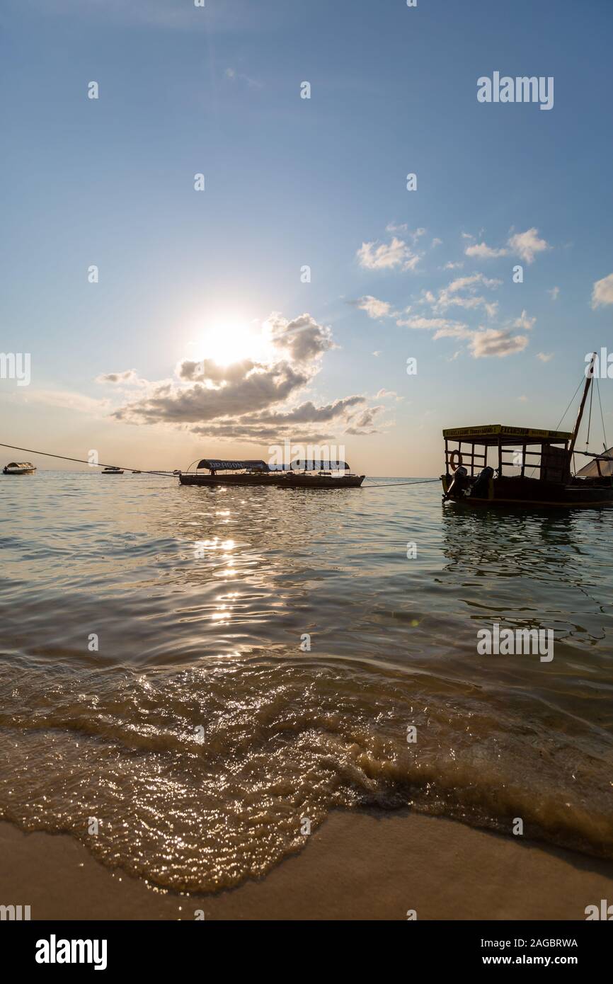Vertical shot of the fishing boats on the sea under the blue sky ...