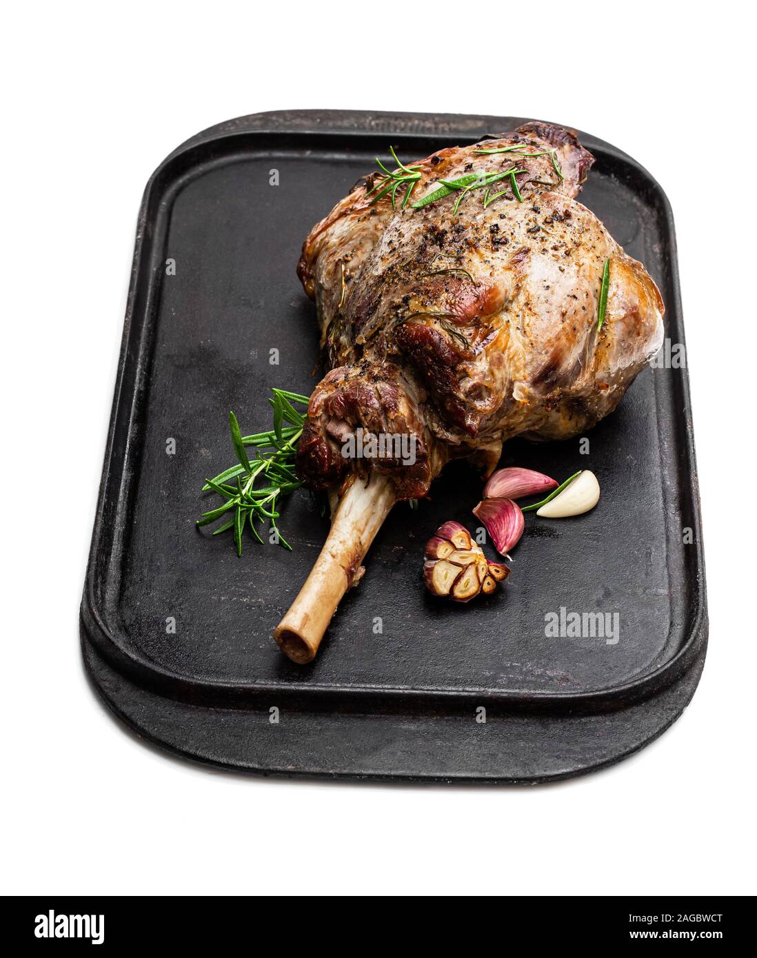 Whole roast lamb leg on grill tray isolated on white Stock Photo - Alamy
