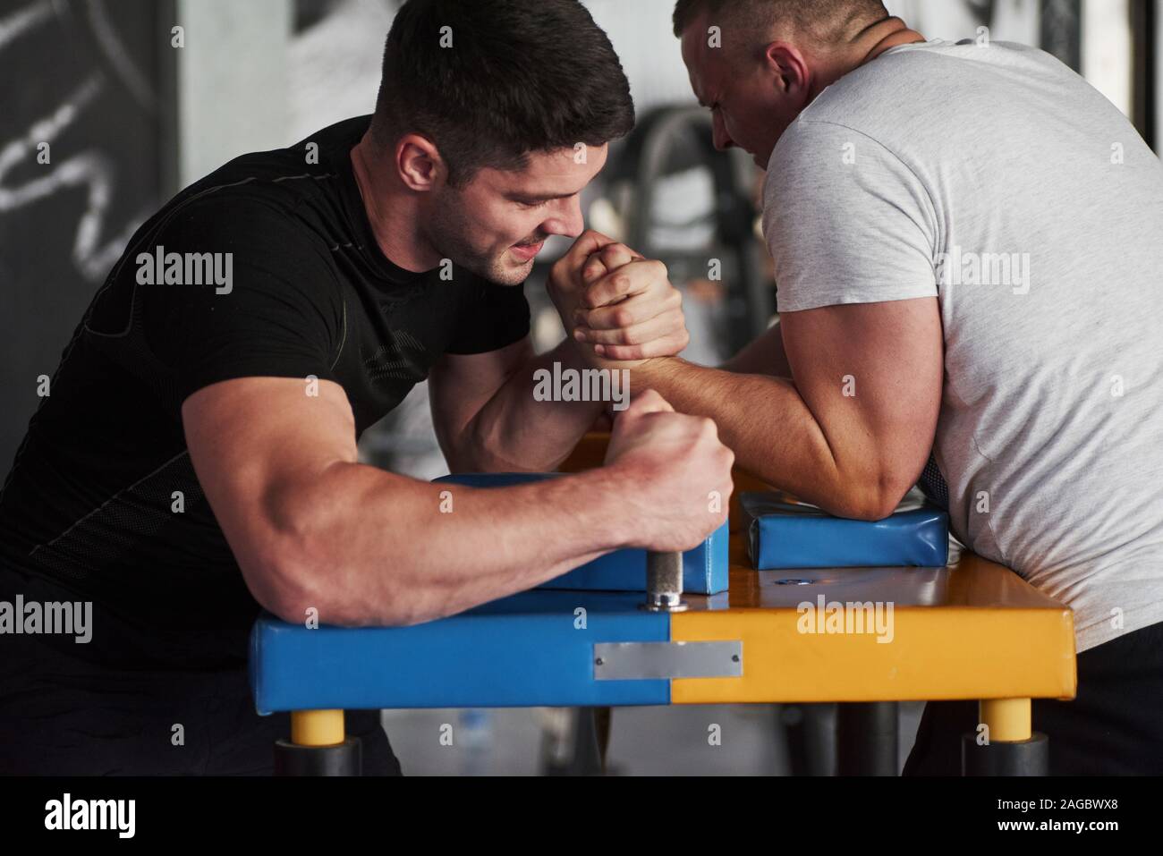 Strength comparison. Arm wrestling challenge between two men. Match on