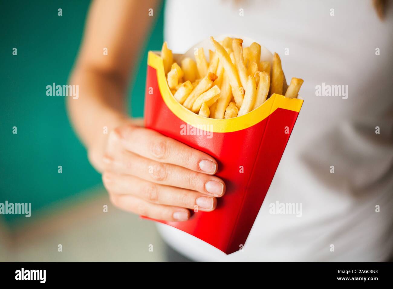 Weight loss and diet. Woman with portion of french fries Stock Photo
