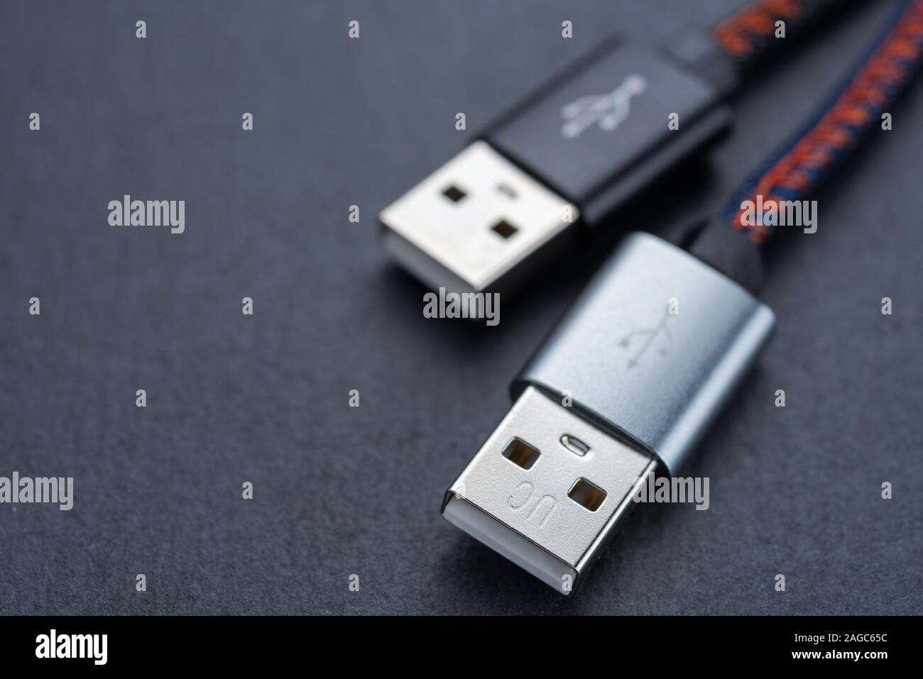 USB cable with cable against a dark background.. Stock Photo