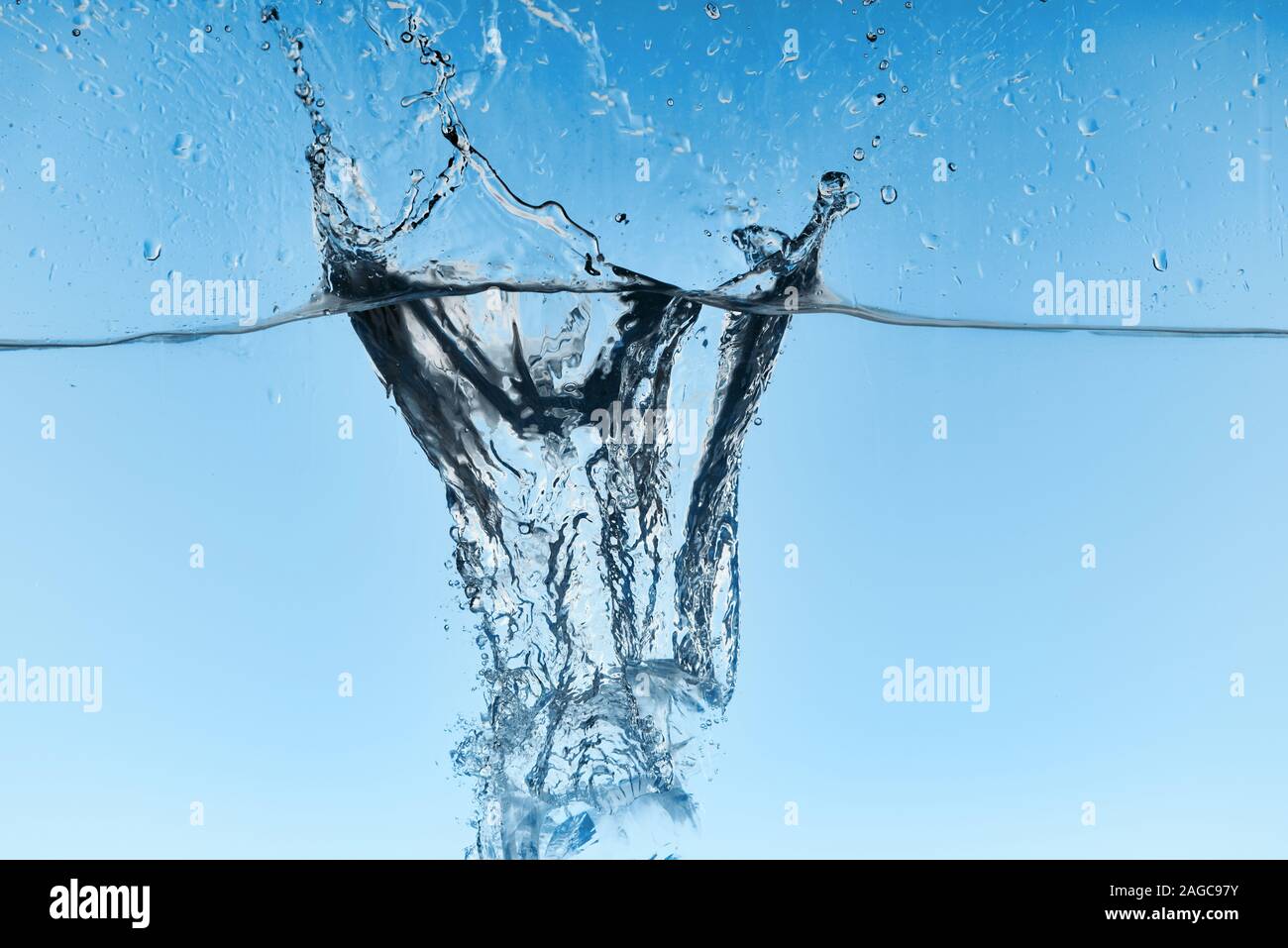 clear water with falling ice cubes and splash on blue background Stock ...